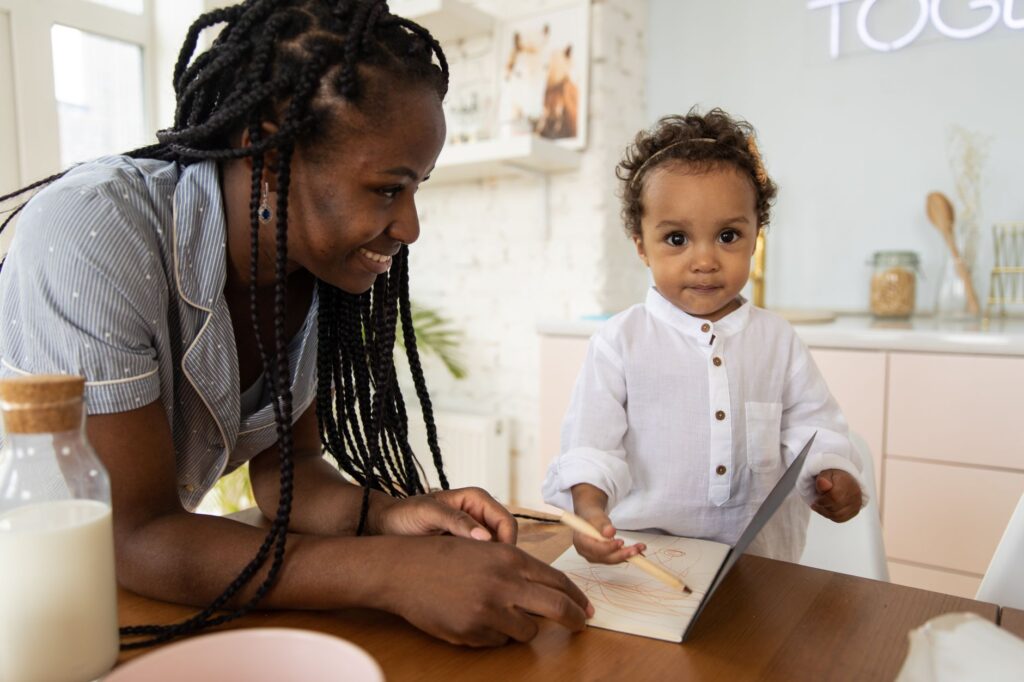 Parent comparing childcare costs and schedules at a kitchen table
