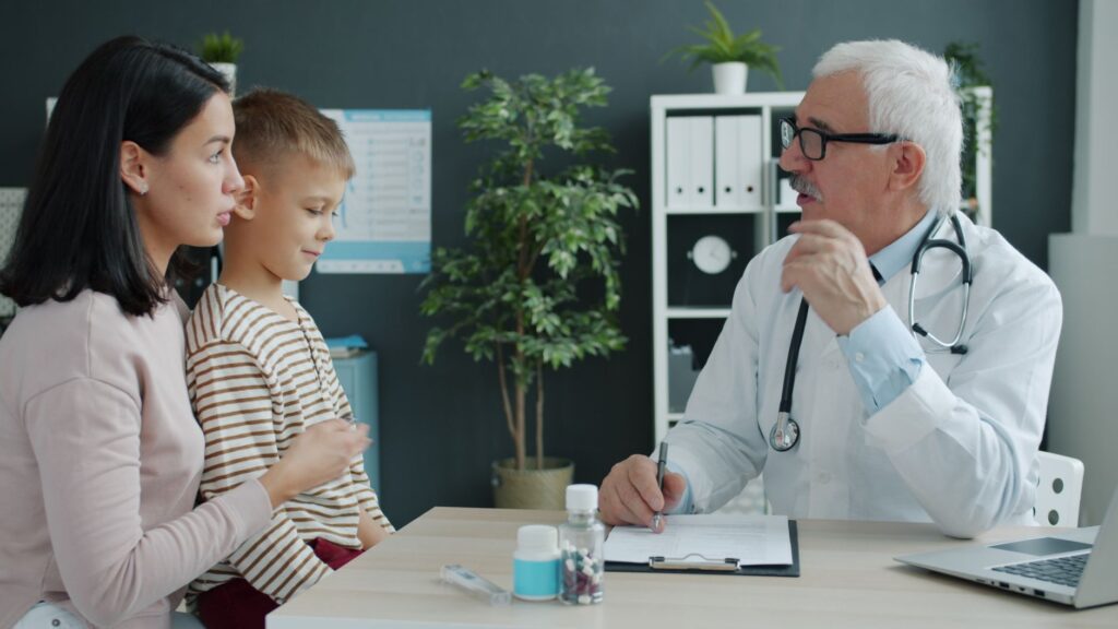 Patient speaking with a family doctor in a primary care examination room
