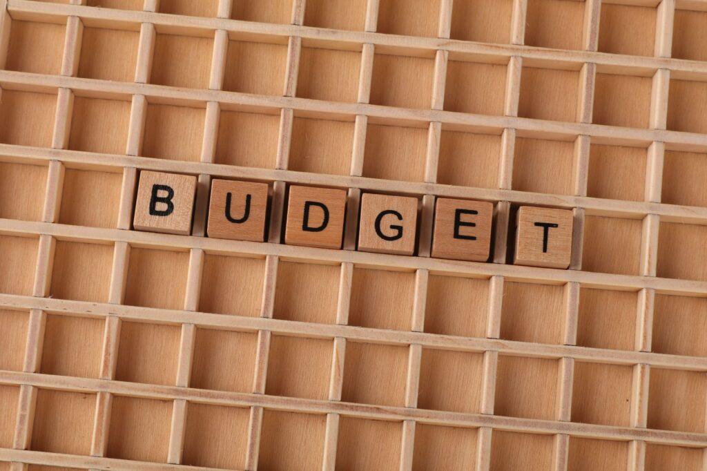 Newcomer in Canada comparing a spreadsheet budget with a mobile budgeting view