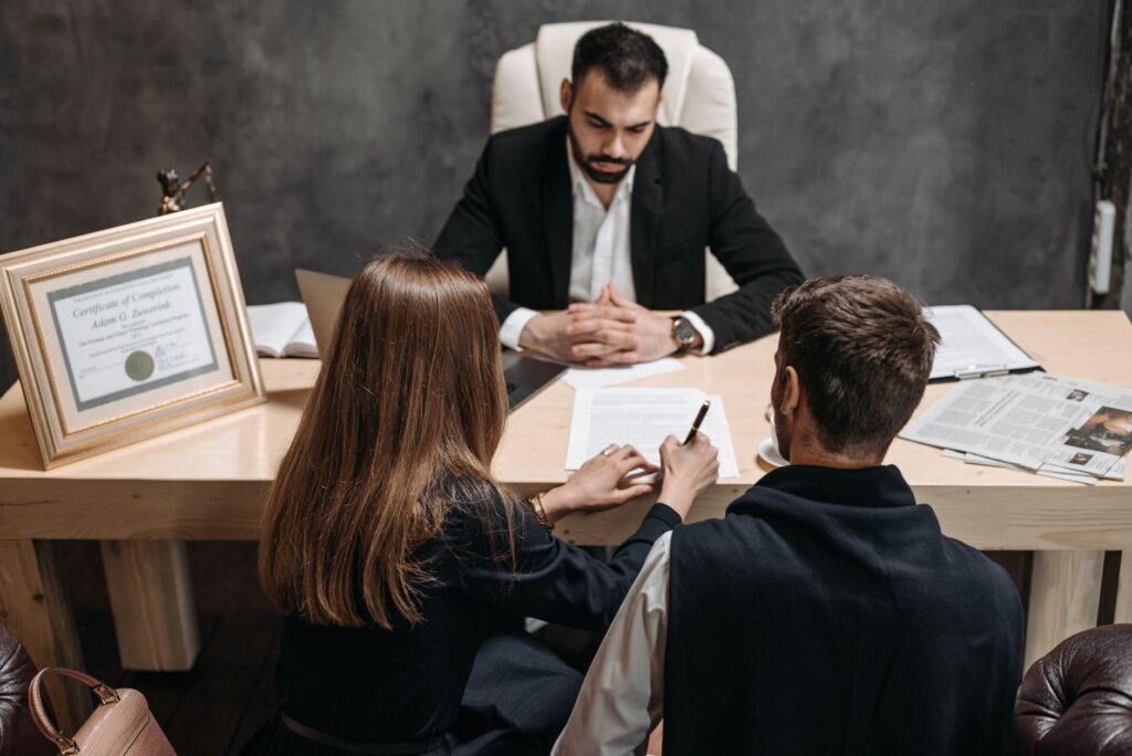 A client discusses legal documents with an adviser at a community legal clinic